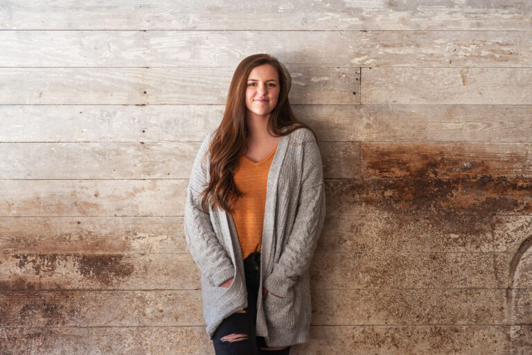 New Hampshire Senior Portrait of woman in rustic barn