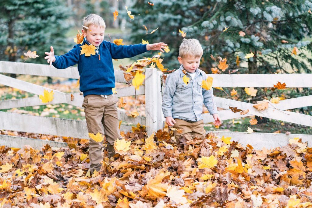 woodstock vermont family photo session: boys playing in autumn leaves