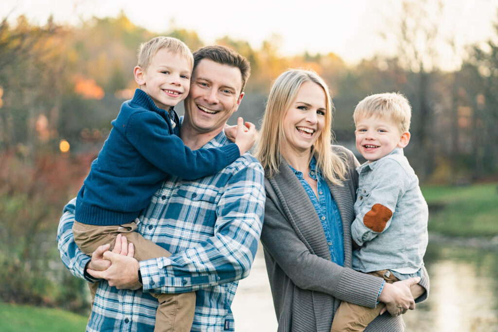 woodstock vermont family photo session: each parent holding a child and standing close together