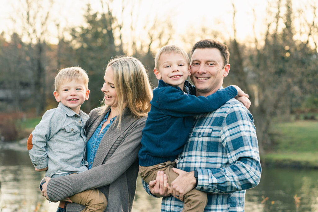 woodstock vermont family photo session: parents holding kids at golden hour