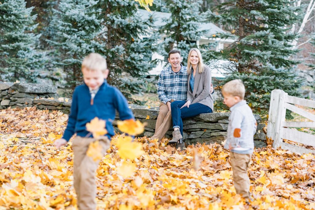 woodstock vermont family photo session: young sons playing with parents in background