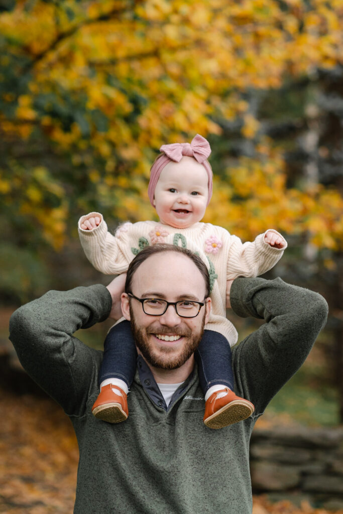 baby on father's shoulders during woodstock vermont fall family photo session