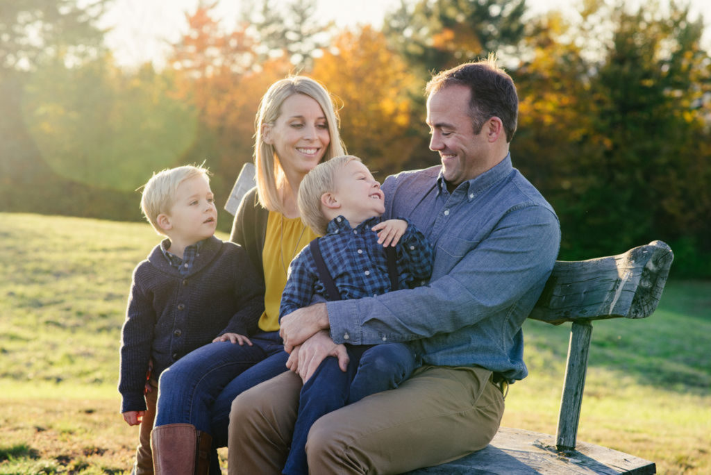 family sitting on bench at golden hour, nh fall foliage, upper valley photo session, langwood farm