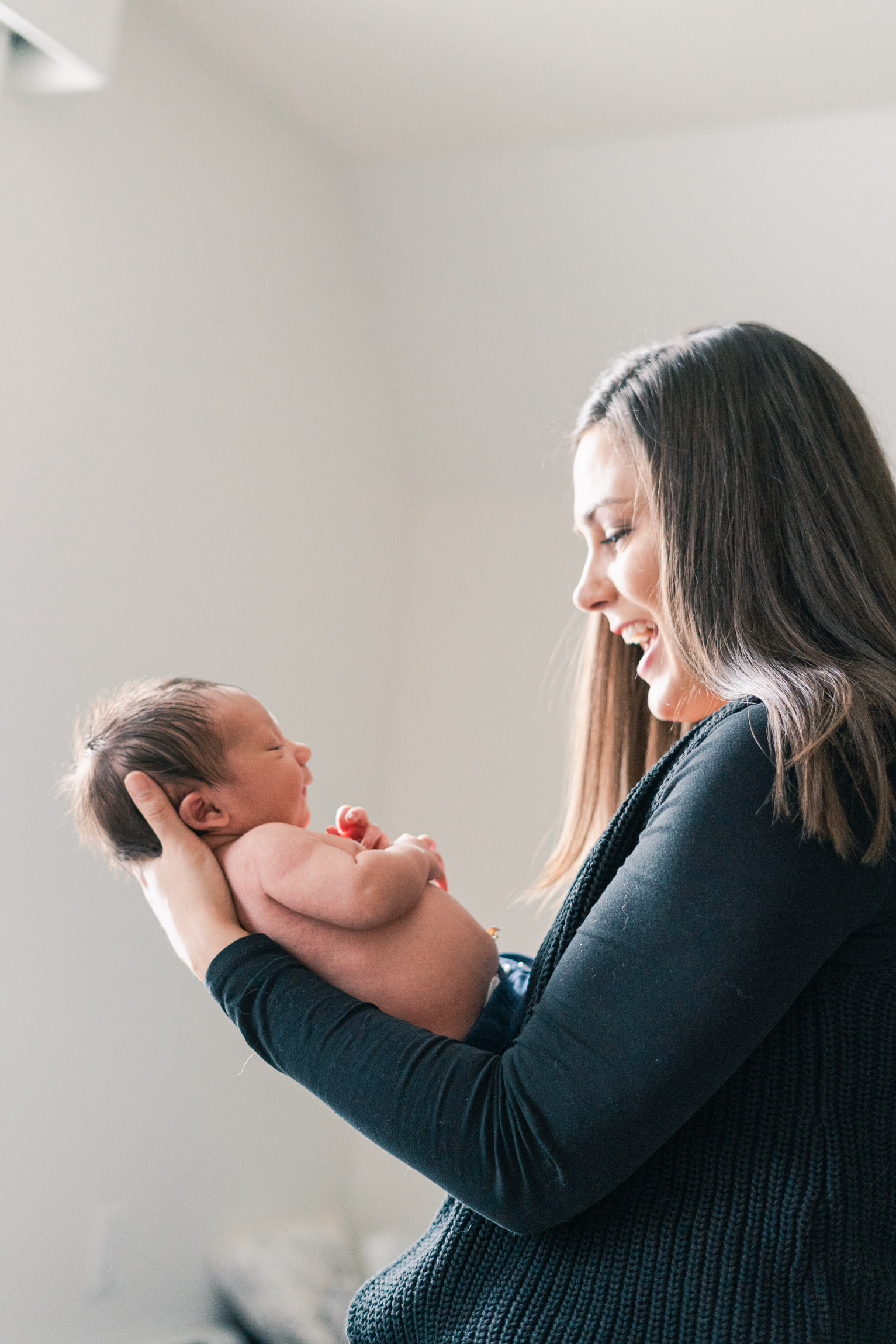 happy image of mother looking at son with light on face