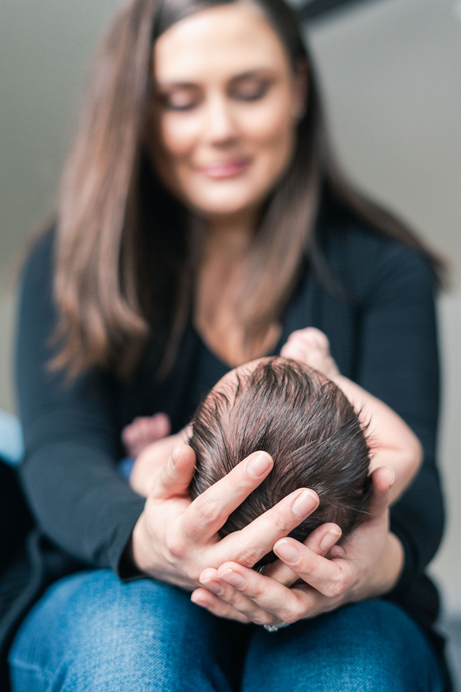 mother cradling baby's head in hands