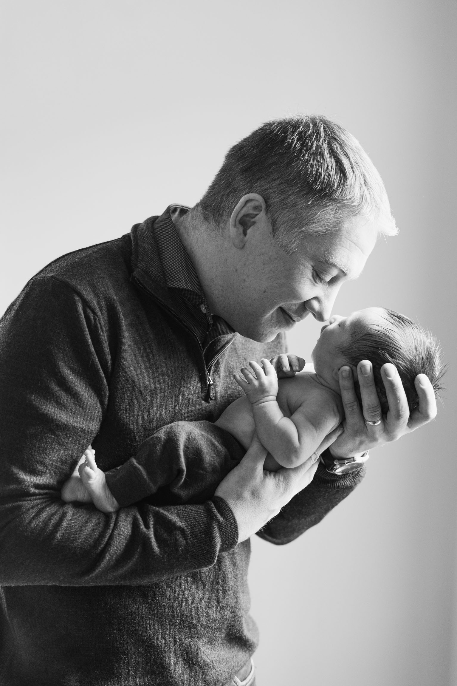 father nose to nose with newborn