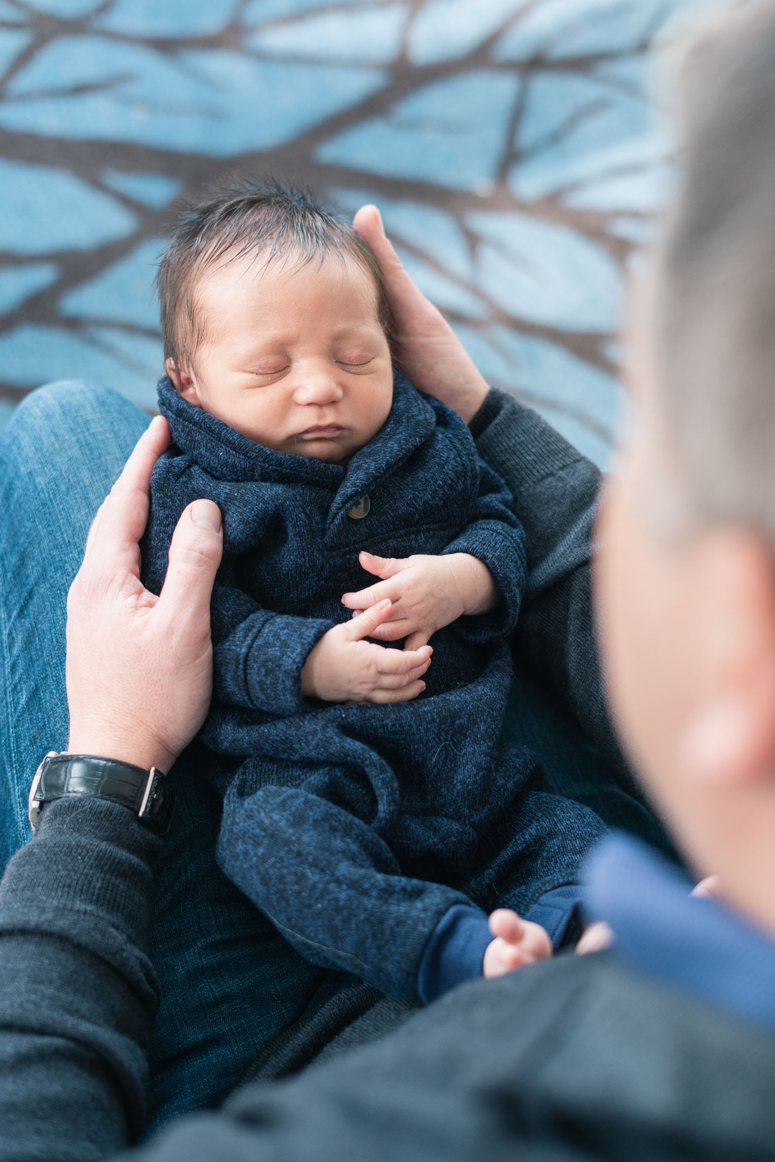 father holding newborn in lap