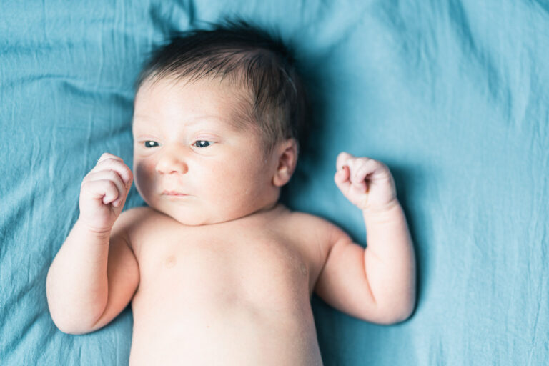 newborn on blue blanket