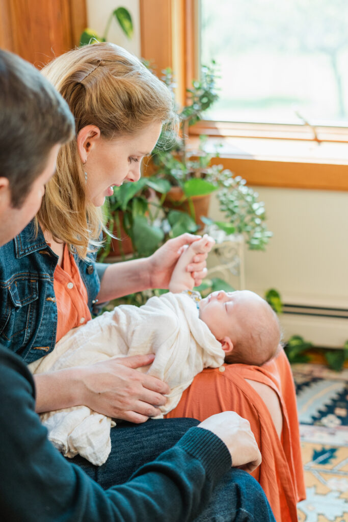 parents holding baby in lap