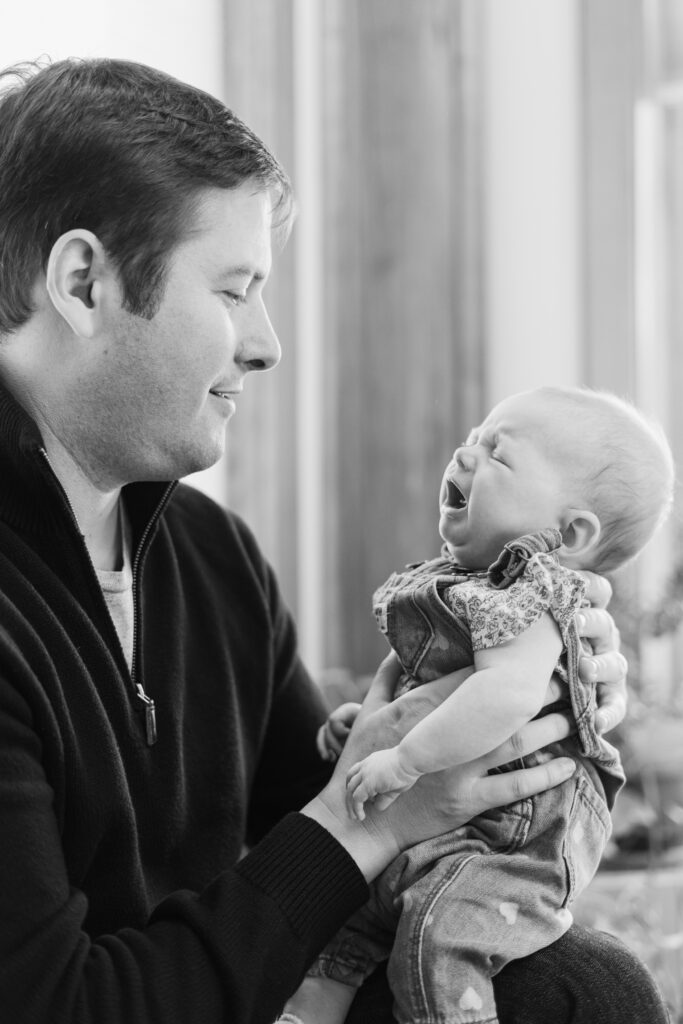 dad holding crying baby