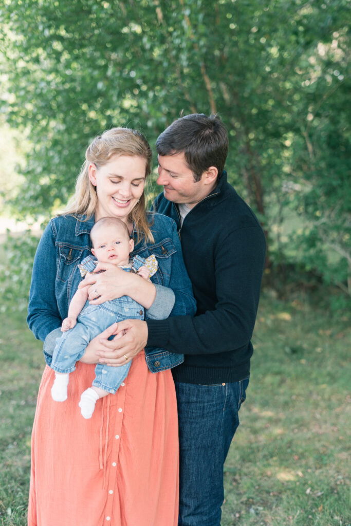 mom and dad holding baby