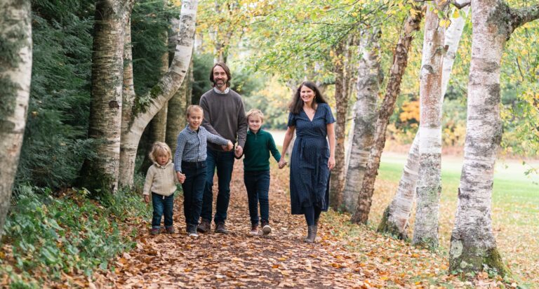 family walking down birch alley at Saint-Gaudens in Cornish, NH