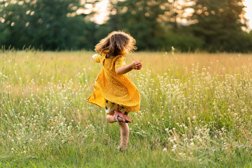 Girl twirling in the fall field