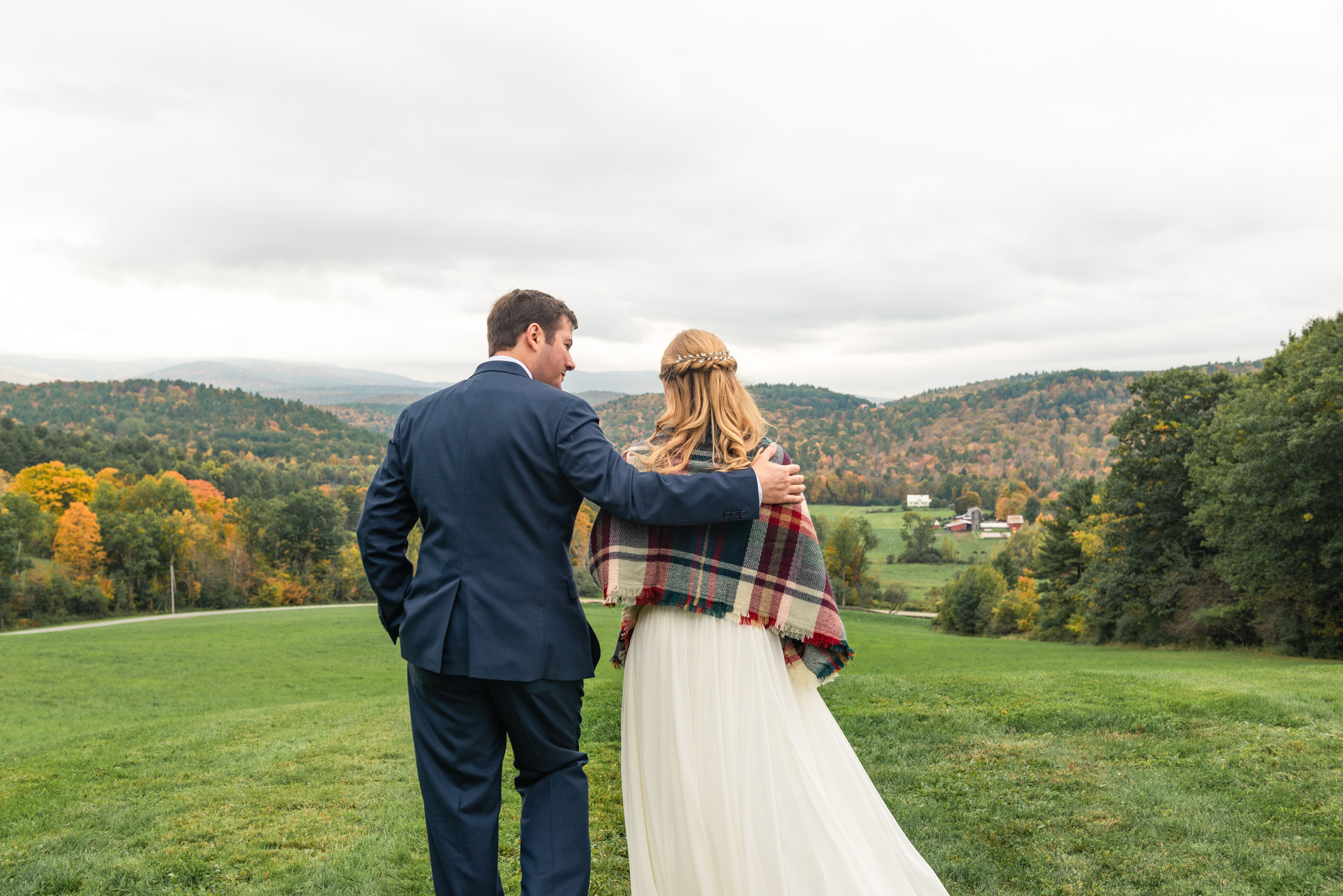 Bridal couple standing and looking out at view