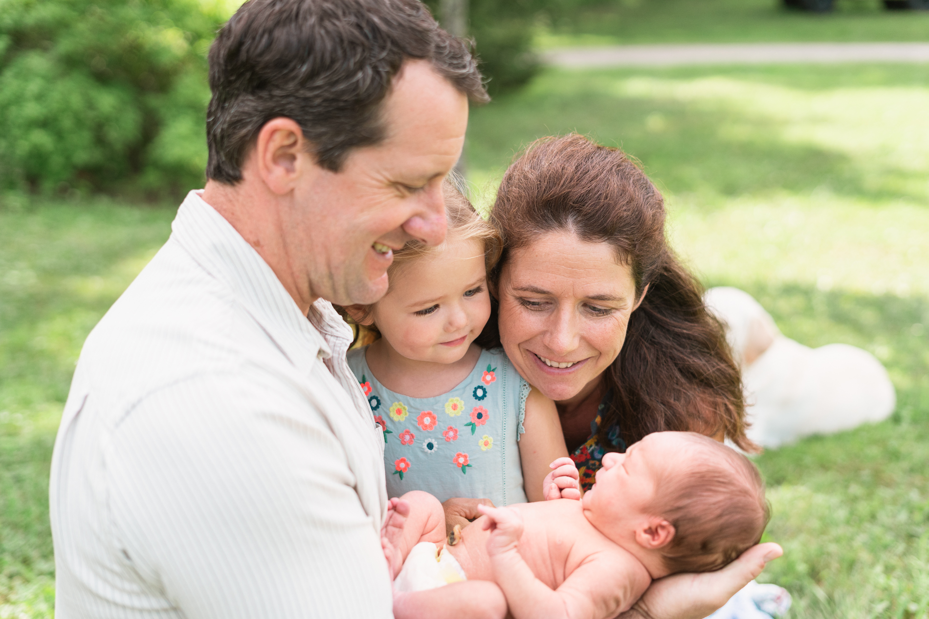 Family looking down at newborn brother