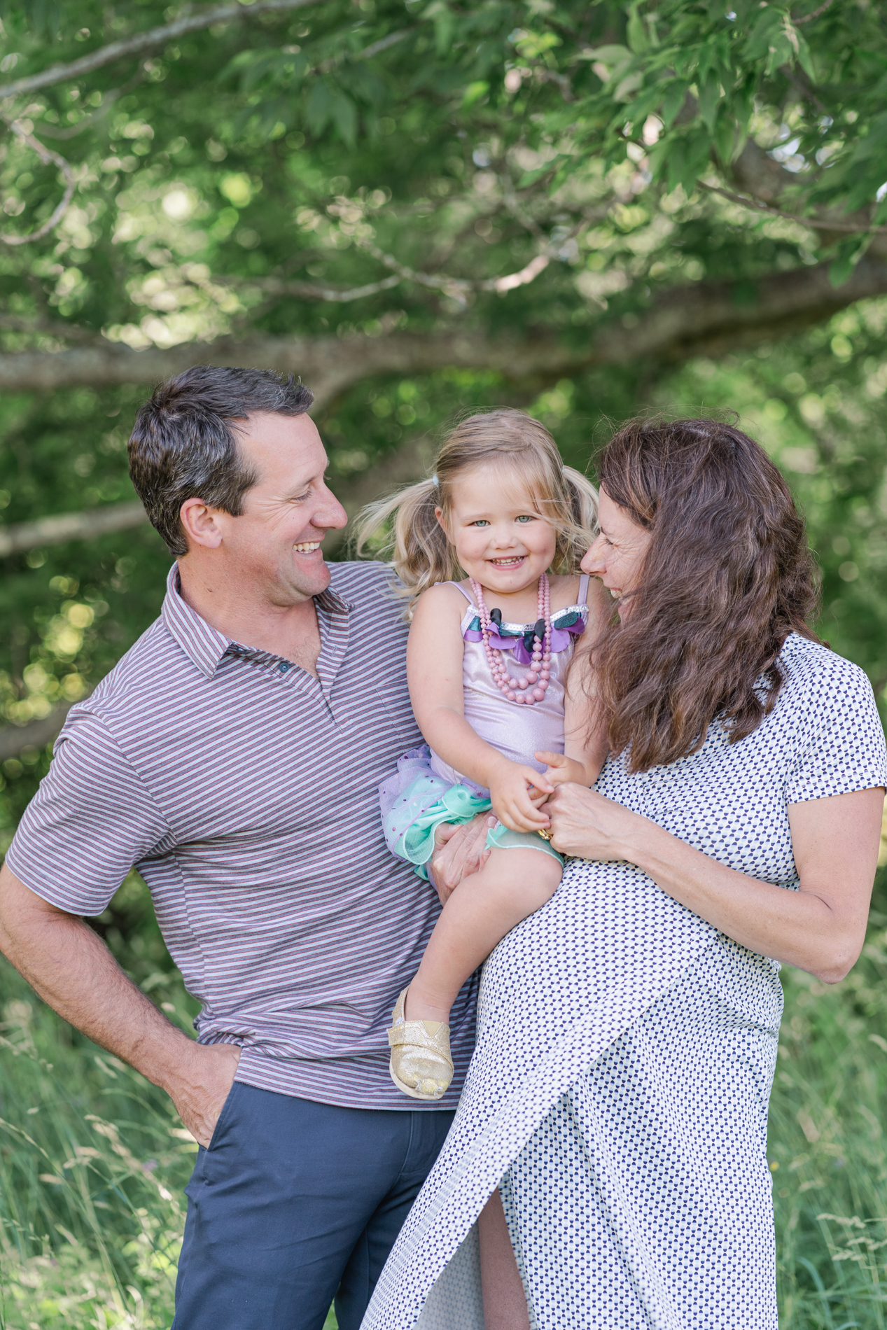 Pregnant mom posing with child and husband