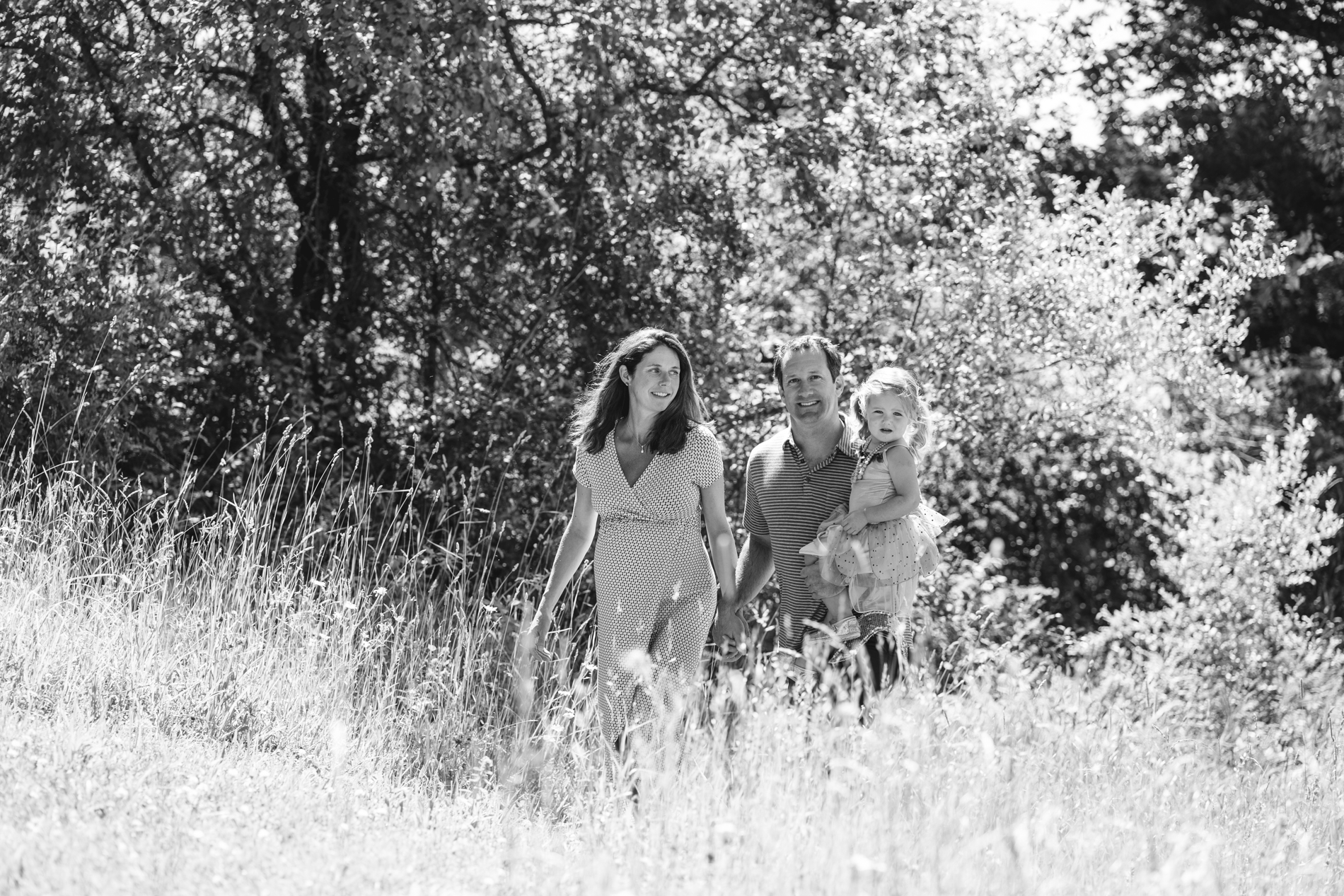 family walking through tall grass in vermont