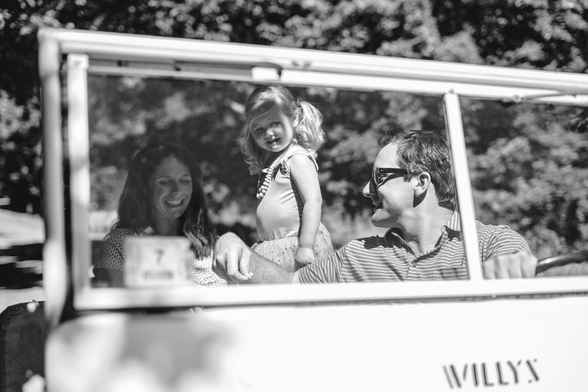 Family riding in old Willy Jeep