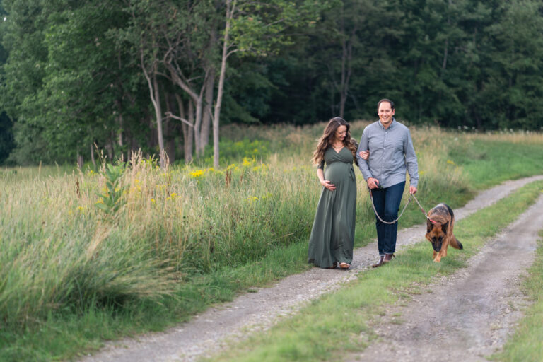 pregnant couple walking down path