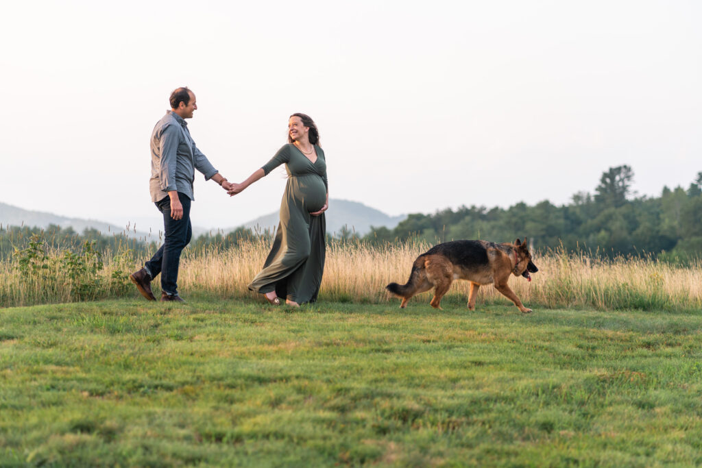 Couple walking along ridgeline with dog