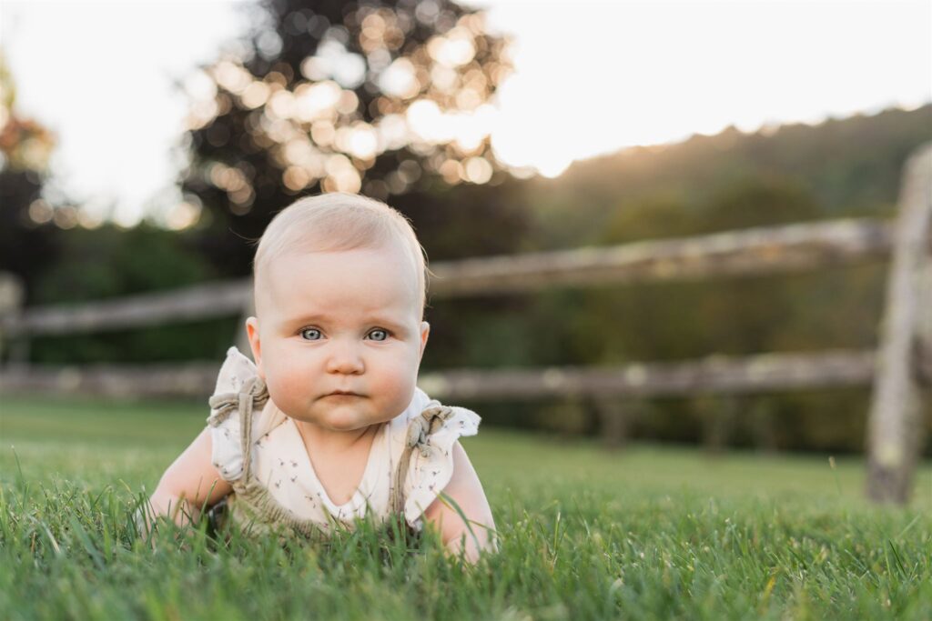 portrait of baby on grass with sunset