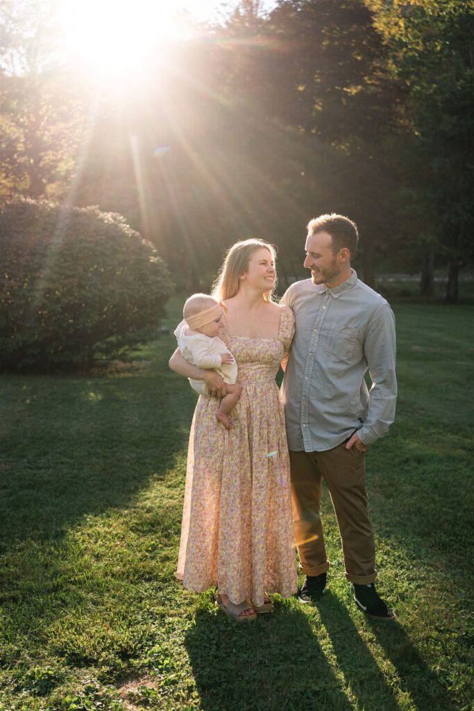 family standing under sunburst looking at each other