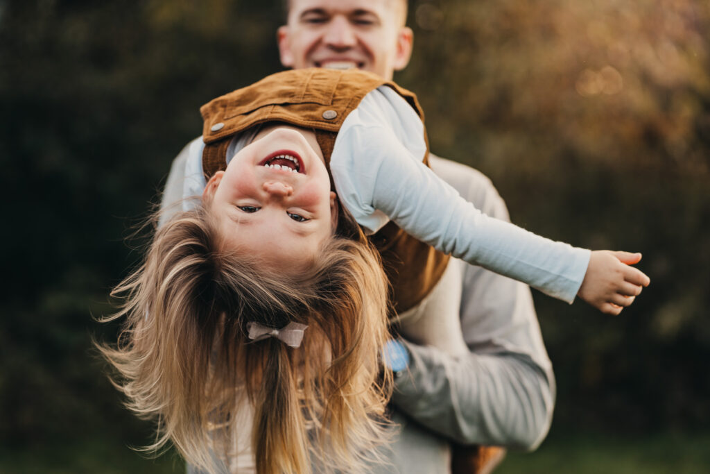 kids looking upside down with dad