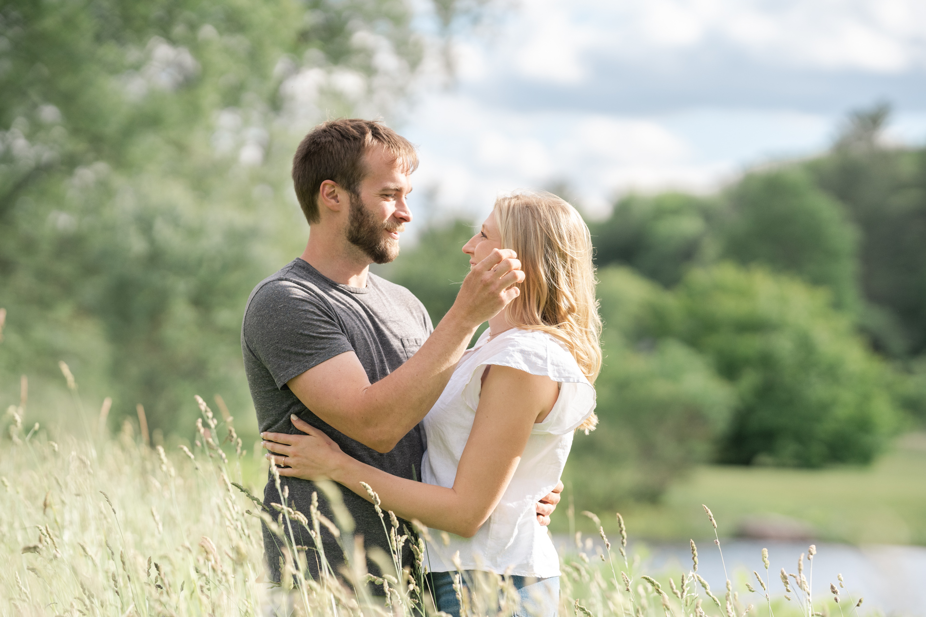 couple standing in field at riverledge farm in grafton vermont