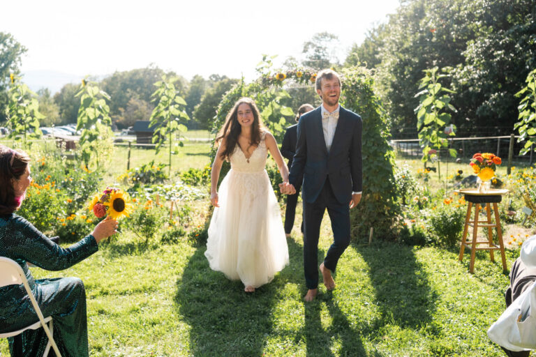 Bride and groom just married in community garden, bright sunlight