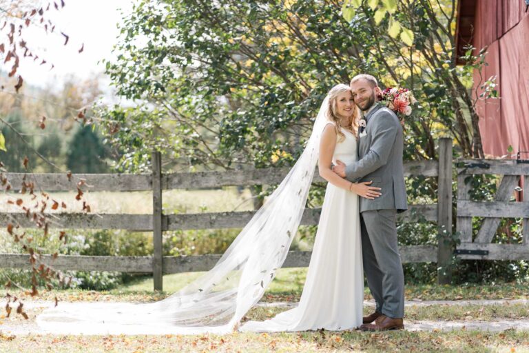 Vermont wedding at Riverledge Farm, bride and groom smile at camera