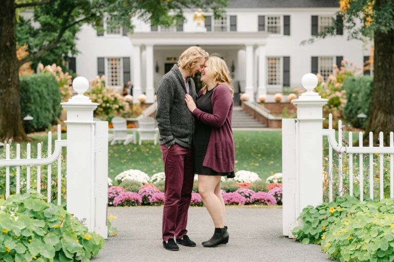 Fall engagement session in Woodstock. Couple standing in front of Woodstock Inn