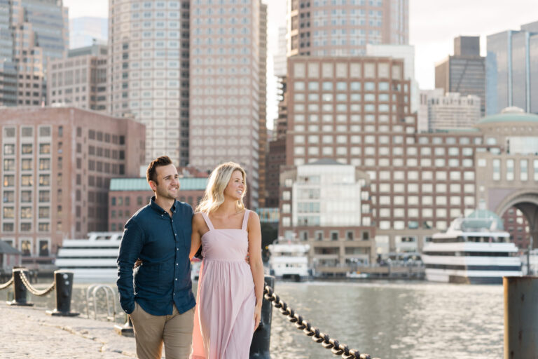 couple walking along the boston harborwalk in the seaport district