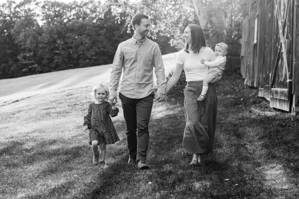couple with children walking behind barn at langwood farm