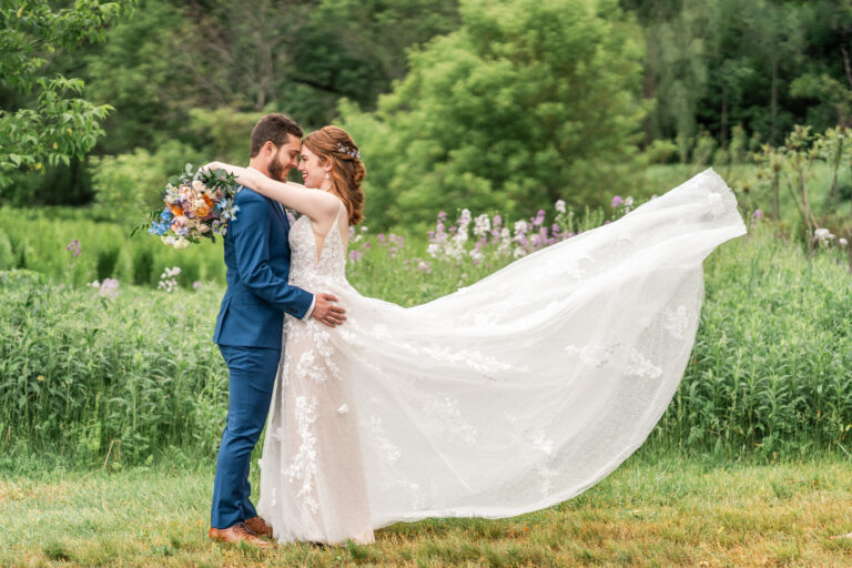 Bride and Groom, dress toss during first look at Quechee Inn at Marshland Farm
