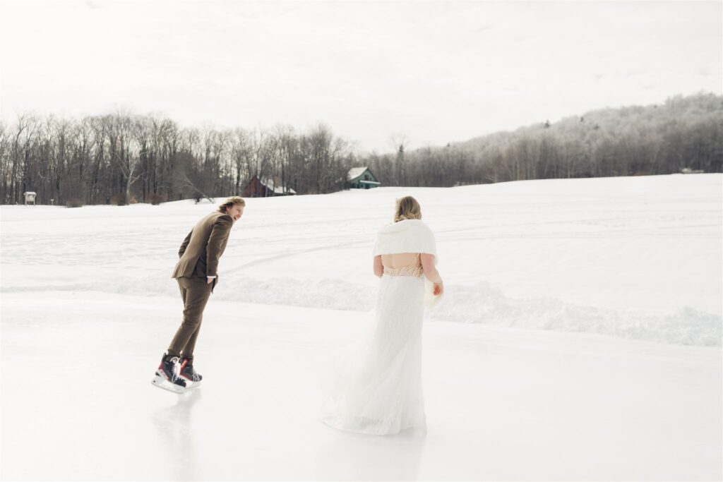 groom skating behind bride at mountain top inn, chittenden, vt