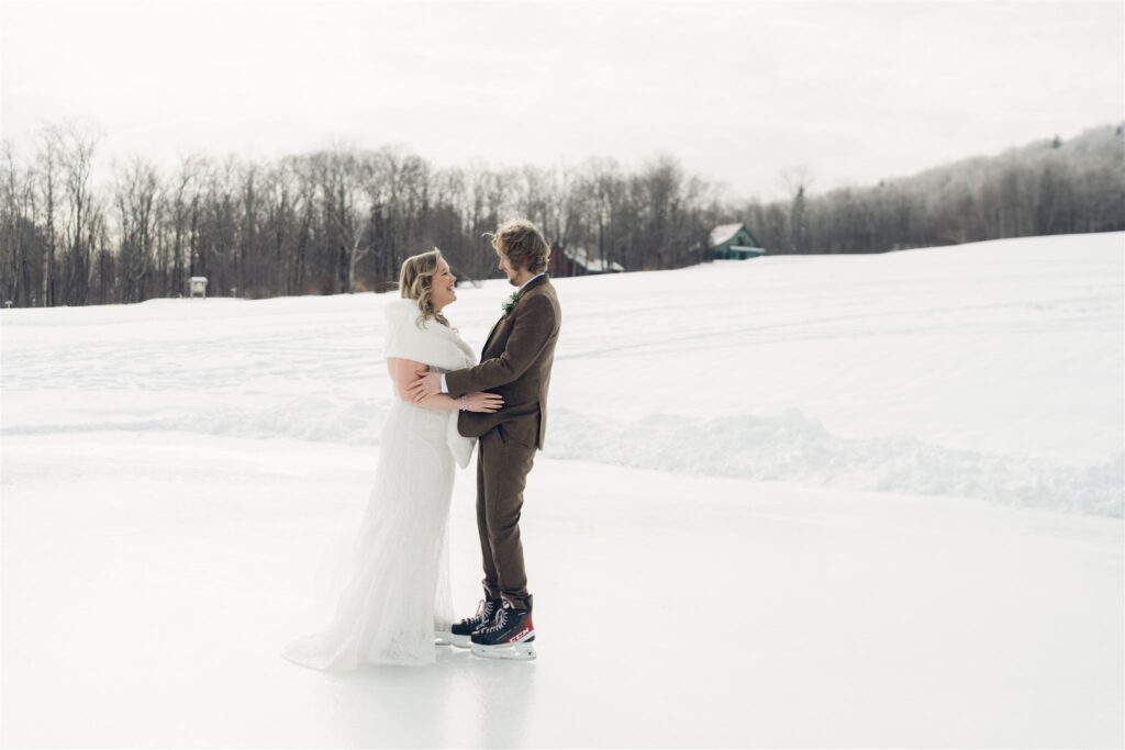 bride and groom holding eachother on ice at mountain top inn, chittenden, vt