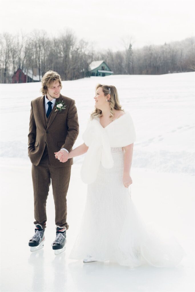 couple holding hands on ice rink at mountain top inn, chittenden, vt