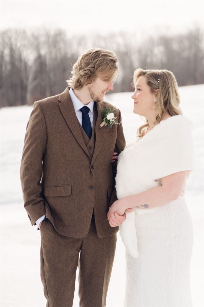 couple looking at eachother and holding hands during first look at mountain top inn, chittenden, vt