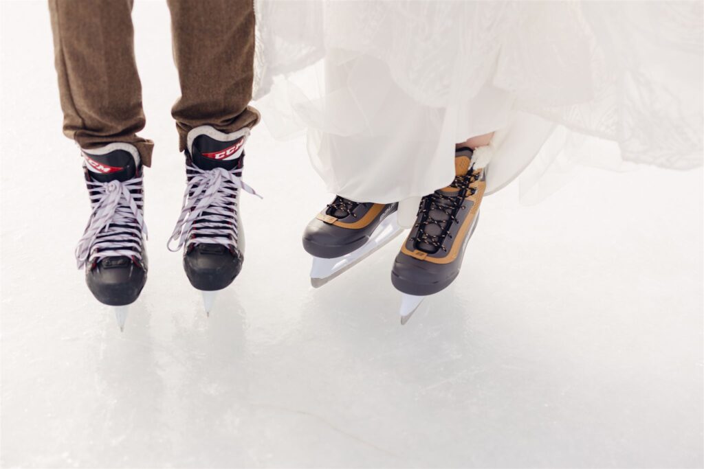 detail shot of bride and groom in pants and dress and ice skates during first look at mountain top inn, chittenden, vt
