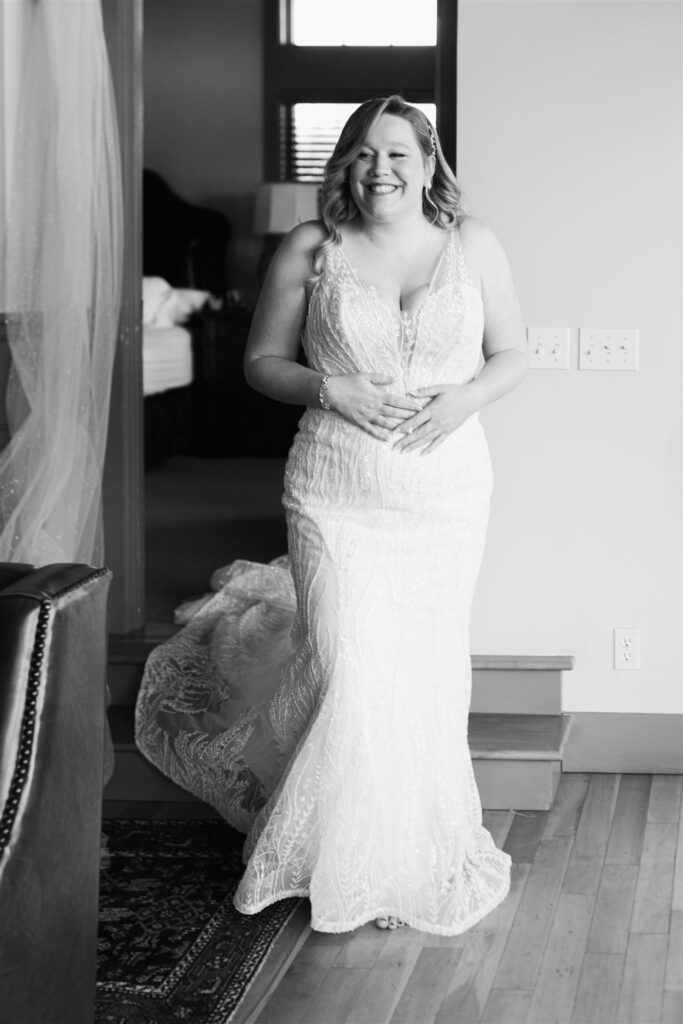 bride stepping out to show wedding party her dress at mountain top inn, chittenden, vt
