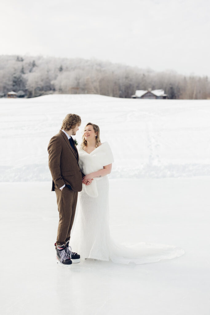 portrait of couple standing on ice at mountain top inn, chittenden, vt