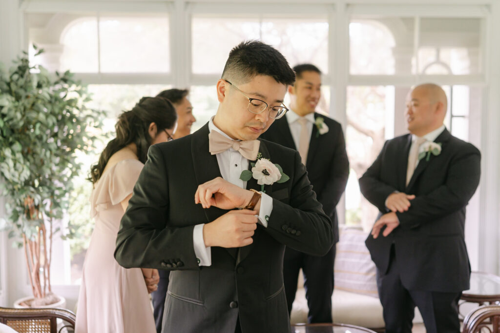 Groom getting ready with attendants