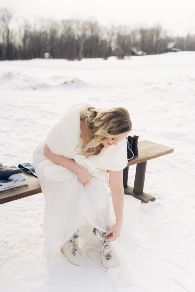 bride taking off ice skates at mountain top inn, chittenden, vt