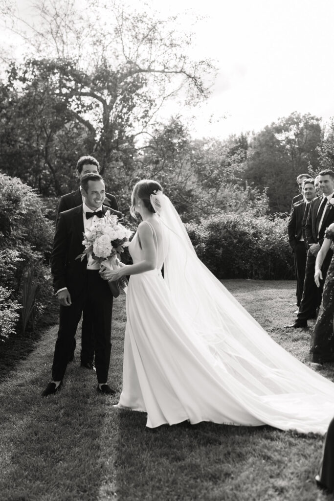 Bride Walking up the aisle to her groom on wedding day at the ceremony at The Fells in Newbury NH