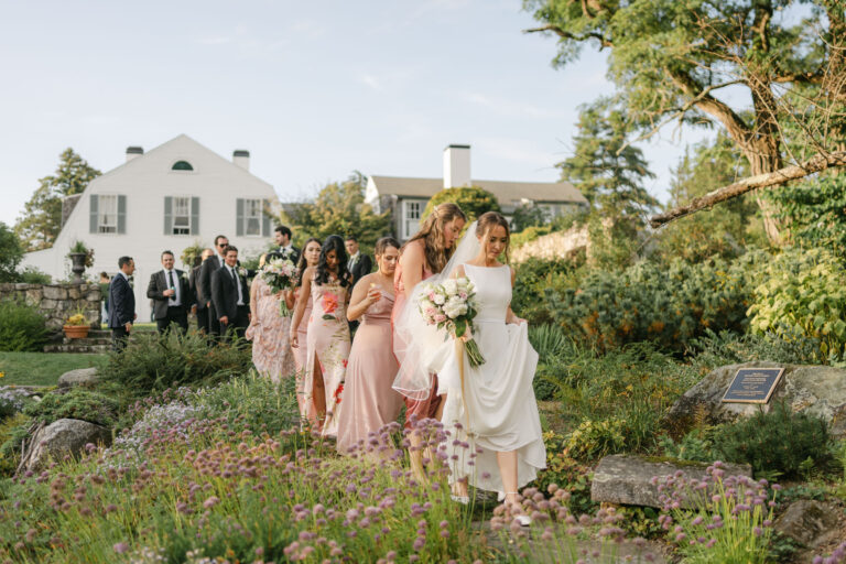 wedding party walking through garden at the fells