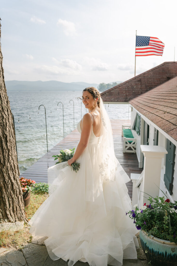 bride standing on dock looking out over water