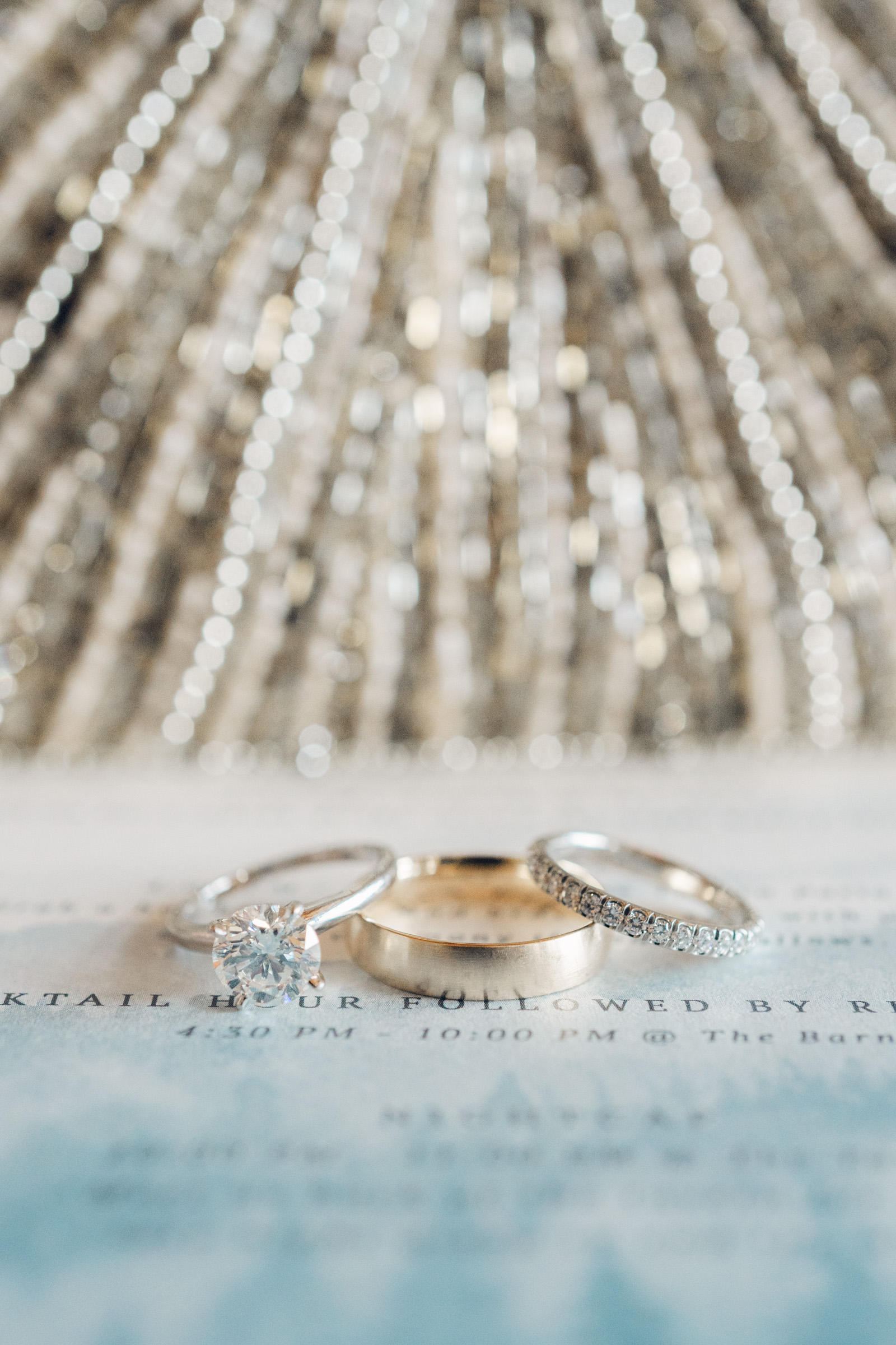 engagement rings on invite with beaded purse