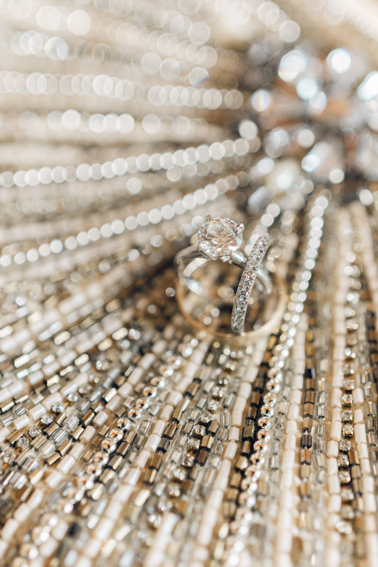 sparkling engagement rings on beaded purse