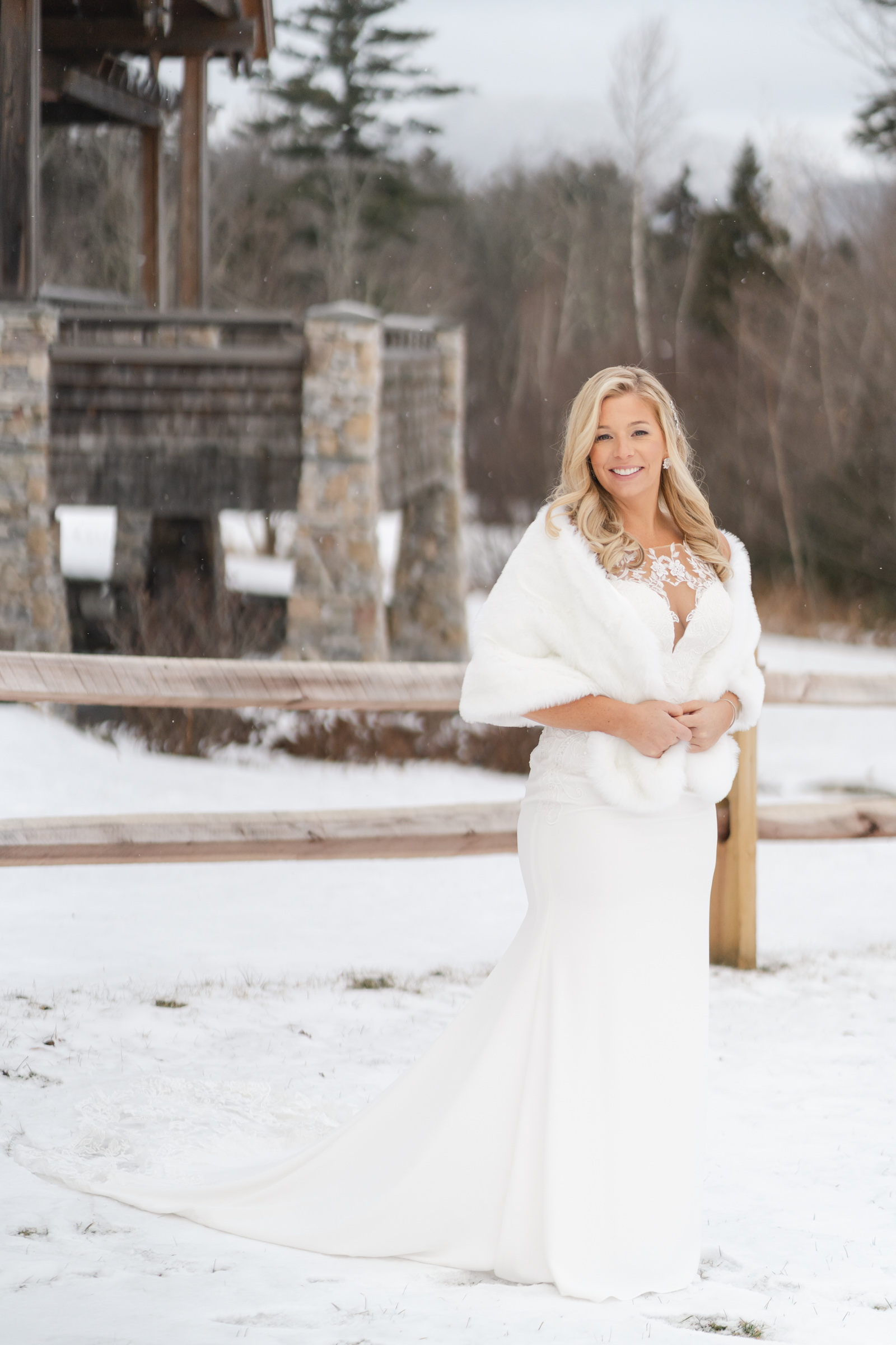bride stands on snowy field during Vermont Wedding at The Jewel at Mountain Top Inn