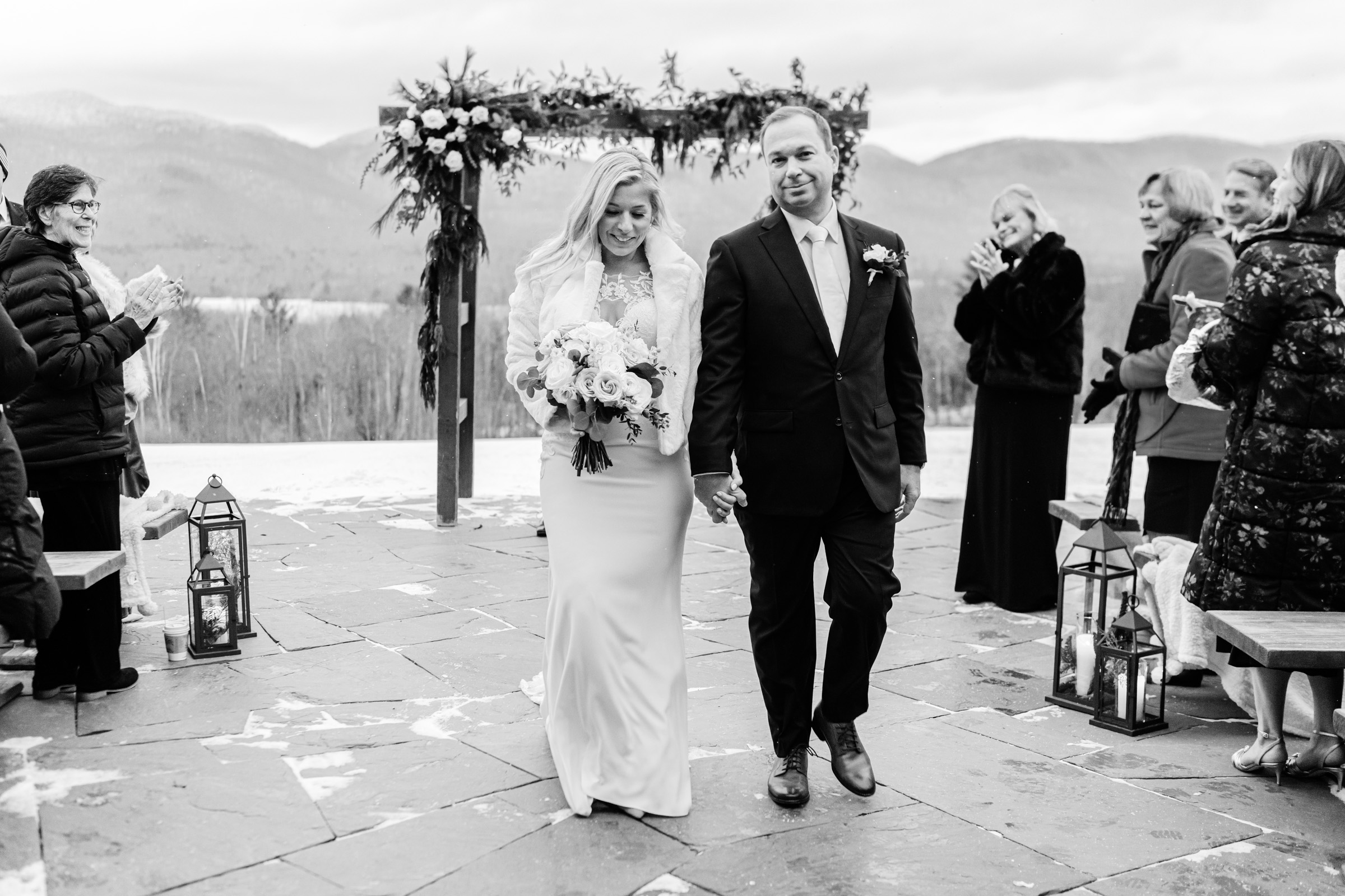 couple recess down aisle after married at mountain top resort in chittenden